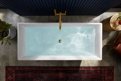 Floor-mount bath filler trim with handshower