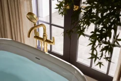Floor-mount bath filler trim with handshower