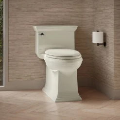 One-piece compact elongated toilet with skirted trapway, 1.28 gpf