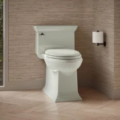 One-piece compact elongated toilet with skirted trapway, 1.28 gpf