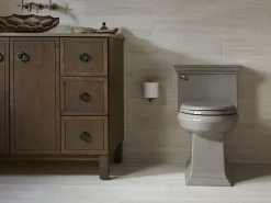 One-piece compact elongated toilet with skirted trapway, 1.28 gpf