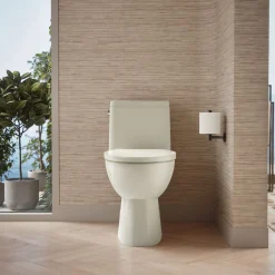 One-piece compact elongated toilet with skirted trapway, 1.28 gpf