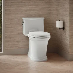 One-piece compact elongated toilet with skirted trapway, 1.28 gpf