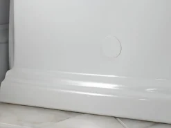 One-piece compact elongated toilet with skirted trapway, 1.28 gpf