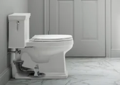 One-piece compact elongated toilet with skirted trapway, 1.28 gpf