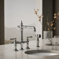 Three-hole bridge bar sink faucet with side sprayer