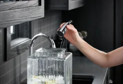 Touchless pull-down kitchen sink faucet with three-function sprayhead