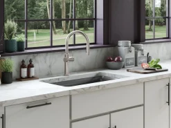 Touchless pull-down kitchen sink faucet with three-function sprayhead