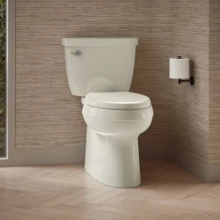 Two-piece elongated toilet with skirted trapway, 1.28 gpf