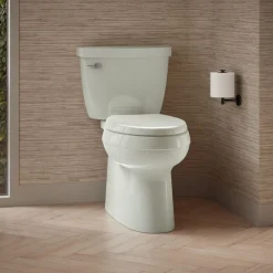 Two-piece elongated toilet with skirted trapway, 1.28 gpf