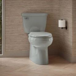 Two-piece elongated toilet with skirted trapway, 1.28 gpf