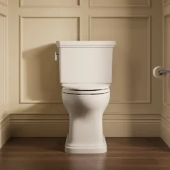 Two-piece elongated toilet with skirted trapway, 1.28 gpf