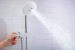 Wall-mount handshower holder with supply elbow and volume control